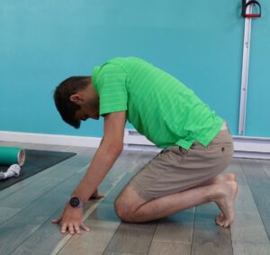 Dr. Jon stretching his toes and the bottom of his feet with kneeling toe extensions